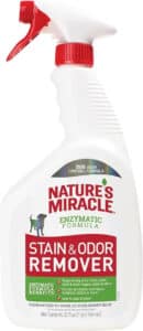 Bottle of Nature's Miracle Dog Stain and Odor Remover with a happy dog and clean surfaces in the background
