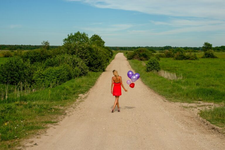 Dog owner walking rural dirt road