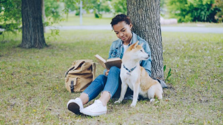 Person reading dog breed book puppy